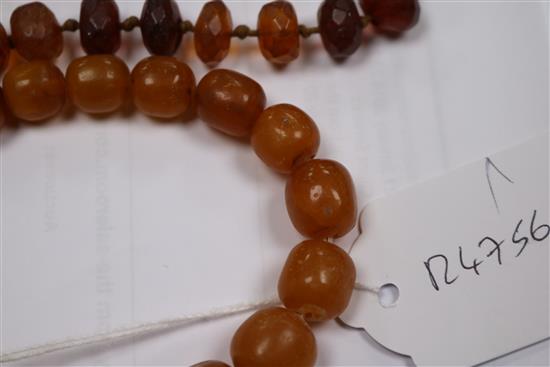 Five assorted amber necklaces.